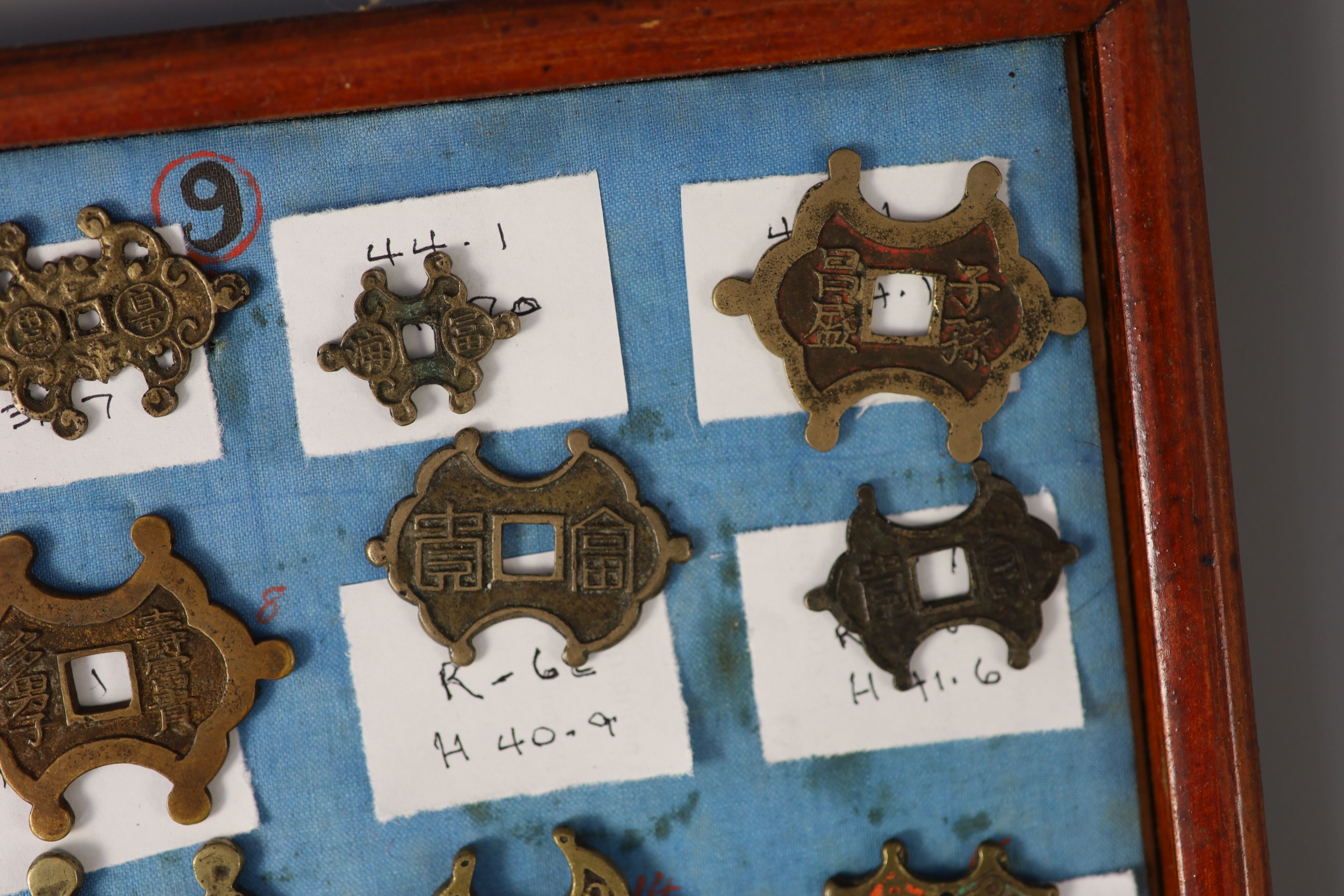 A group of 99 Korean bronze and metal amulets or charms, 19th/20th century
